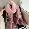 Detailed close-up of pink cherry blossom and butterfly embroidery on gradient silk scarf - Gradient Bean Paste