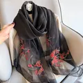 Detail of silk wool blend scarf with delicate red flower embroidery on semi-sheer black fabric - Elegant Black