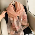 Close-up of elegant pink silk wool scarf with intricate floral embroidery details - Pink