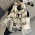 Detail of classic plaid silk shawl featuring fine beige and khaki checkered texture - Beige
