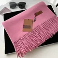 Pink cashmere feel scarf with fringe tassels and premium brand tag on display - Dusty Pink