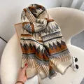 Detail of bohemian geometric scarf with dense fringe on a cozy white armchair - 190cm / Beige