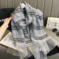 Detail of silk plaid scarf with metallic gold threads and camellia flower brooch decor - Gray