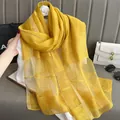 Close-up of bright yellow silk mohair scarf with golden thread and subtle plaid texture - Yellow