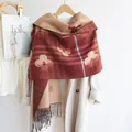 Detail of red floral check knit scarf with fringes on a white woolen coat - Red
