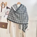 Winter faux cashmere scarf with navy geometric G-pattern and fringe on wool coat - Black & White