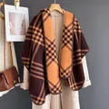 Detail of classic plaid cashmere-feel scarf with neat lockstitch edge on an overcoat - Coffee