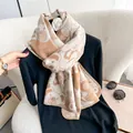 Close-up of thick beige and brown knit scarf with cartoon bear jacquard pattern - Camel Style
