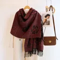 Detail of red knit scarf with camellia patterns and black fringes on white coat - Black Red