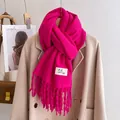 Detail of rose red scarf featuring soft wool-like texture and long fringed tassel edges - Rose Red