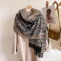 Close-up of bohemian paisley pattern scarf with thick fringe and knit texture - Maya Pattern Black