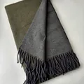 Detailed macro view of olive green and charcoal grey double-sided wool scarf with tassels - Army Green