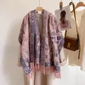 Close-up of thick core-spun yarn shawl with paisley prints and pink tassel details - Maya Pattern Pink