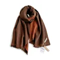 Detail of double-sided knit scarf with fringe in dark brown and burnt orange hues - Caramel