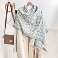 Light blue and beige geometric pattern scarf with fringe on a wooden hanger - Light Blue