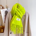 Neon green thick knit scarf with long tassels and stylish woven label detail - Apple Green