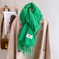 Vibrant green winter scarf with thick tassels and minimalist woven label branding - Oil Green