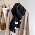 Classic black thick tassel scarf with white woven label on beige wool coat - Black