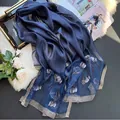 Elegant navy blue silk-blend scarf featuring floral embroidery and silver glitter edges - Navy Blue