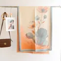 Artistic cashmere-like scarf detail featuring orange and blue floral patterns on a hanger - 185*65cm / Water Lily-Light Blue