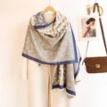Close-up of paisley pattern pashmina scarf with tassel fringe on white coat model - 185 / Green Beige