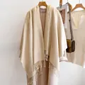 Classic beige wool scarf with fringe tassels displayed on a wooden hanger with coat - 185cm / Beige