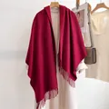 Deep red wool shawl scarf with tassels styled on a beige coat for a classic winter look - 185cm / Burgundy