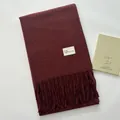 Deep burgundy faux cashmere scarf with fringe details and a minimalist white woven label - Angola Red