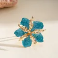 Elegant gold-toned statement ring featuring a vibrant blue enamel crumpled flower petal - Ring / Cyan
