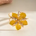 Elegant gold-tone open cuff bracelet with large yellow enamel pleated flower design - Bangle / Yellow