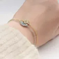 Detail of magnetic sun and moon bracelets with crystals on a beige knit sweater background - Copper / Sun and Moon Bracelet (E2260)