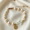Religious pearl bracelet set with gold cross charm and adjustable brown cord - White (1705)