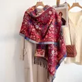 Close-up of vintage paisley pattern and soft tassels on thick red cashmere-like scarf - Red
