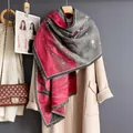 Detail of red and grey gradient scarf with elk silhouettes and fringe edges for winter style - 185cm / Gray