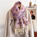 Detail of the purple and beige geometric snowflake pattern and thick fringes on the scarf - Purple