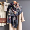 Close-up of navy scarf with magnolia floral print and retro fringe texture detail - Navy Blue