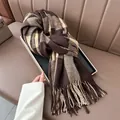 Close-up of thick plaid shawl with fringe detail in brown and cream cashmere-style fabric - Coffee