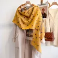 Detail of ginger scarf with polka dots and plaid patterns on light coat with fringe - Multicolor Dots - Yellow