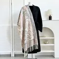 Ethnic paisley cashmere feel pashmina shawl with tassel fringe draped on a coat - Pink Paisley