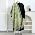 Close-up of ethnic style cashmere scarf with green geometric patterns and tassel fringe - Green