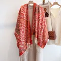 Detail of red ethnic floral cashmere-like scarf with white tassels on beige coat - 190cm / Red