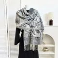Close-up of paisley pattern pashmina shawl with tassel fringe on a white mannequin - Navy Blue Paisley