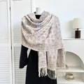 Detail of bohemian paisley pashmina shawl with thick fringe on a white mannequin - Pink