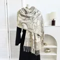 Detailed view of beige paisley jacquard shawl with tassel fringe on a mannequin - Beige Paisley