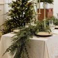 Close-up of 6ft artificial Norfolk pine and eucalyptus garland on a festive dinner table - Christmas Vines / 1.8m