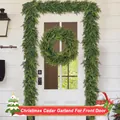 Detail of lifelike Norfolk pine garland and wreath with pine cones on a white front door - Larch Wreath / 40CM