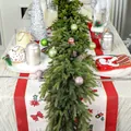 Detail of 6ft Norfolk pine garland with colorful ornaments and pine cones on a festive table - Larch Garland With Decorative Balls / 180cm (With 20 Balls)