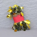 Detail of green tinsel garland with golden leaf sequins wrapped on a festive spool - Standard