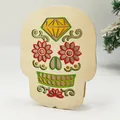 Wooden Day of the Dead sugar skull decoration with colorful floral patterns and pine detail - Skellington Skull