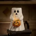 Halloween ghost holding a pumpkin lantern ornament on vintage books with warm glowing light - Ghost Carrying Pumpkin Style A